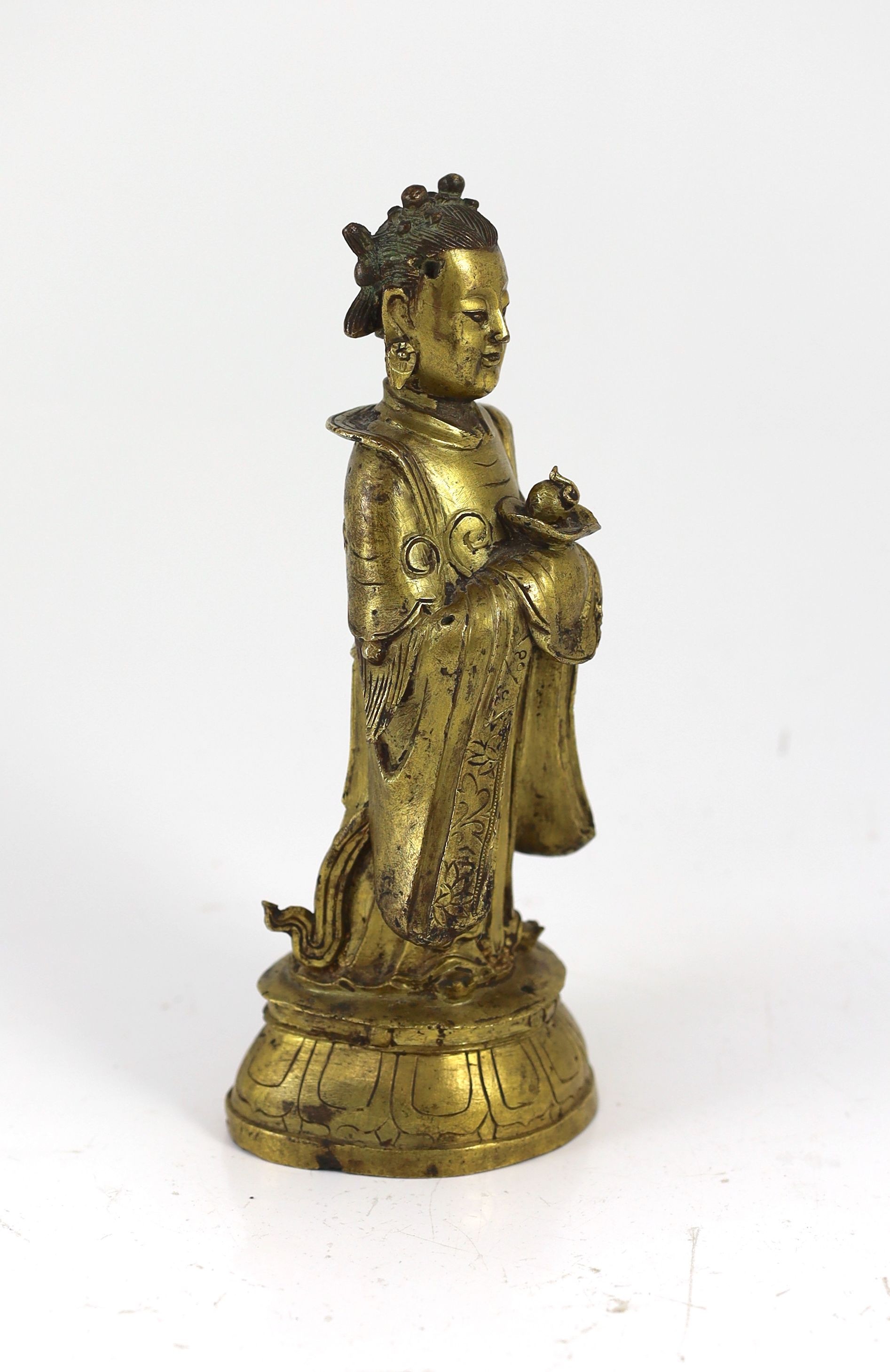 A Chinese Ming gilt bronze figure of an immortal, 16th/17th century, 24.5cm high